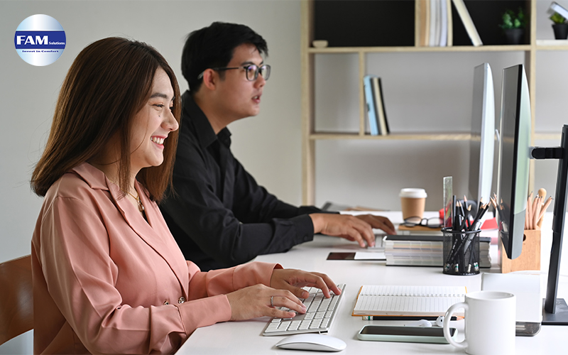 Employees Working Happily On Their Computer